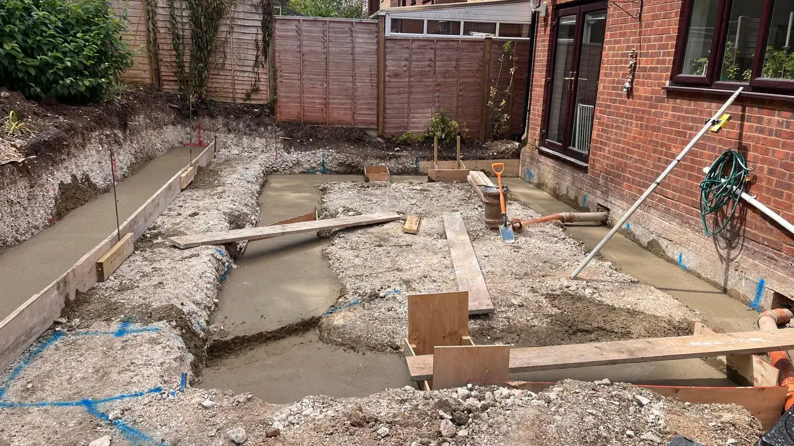 Concrete strip foundations beside a house