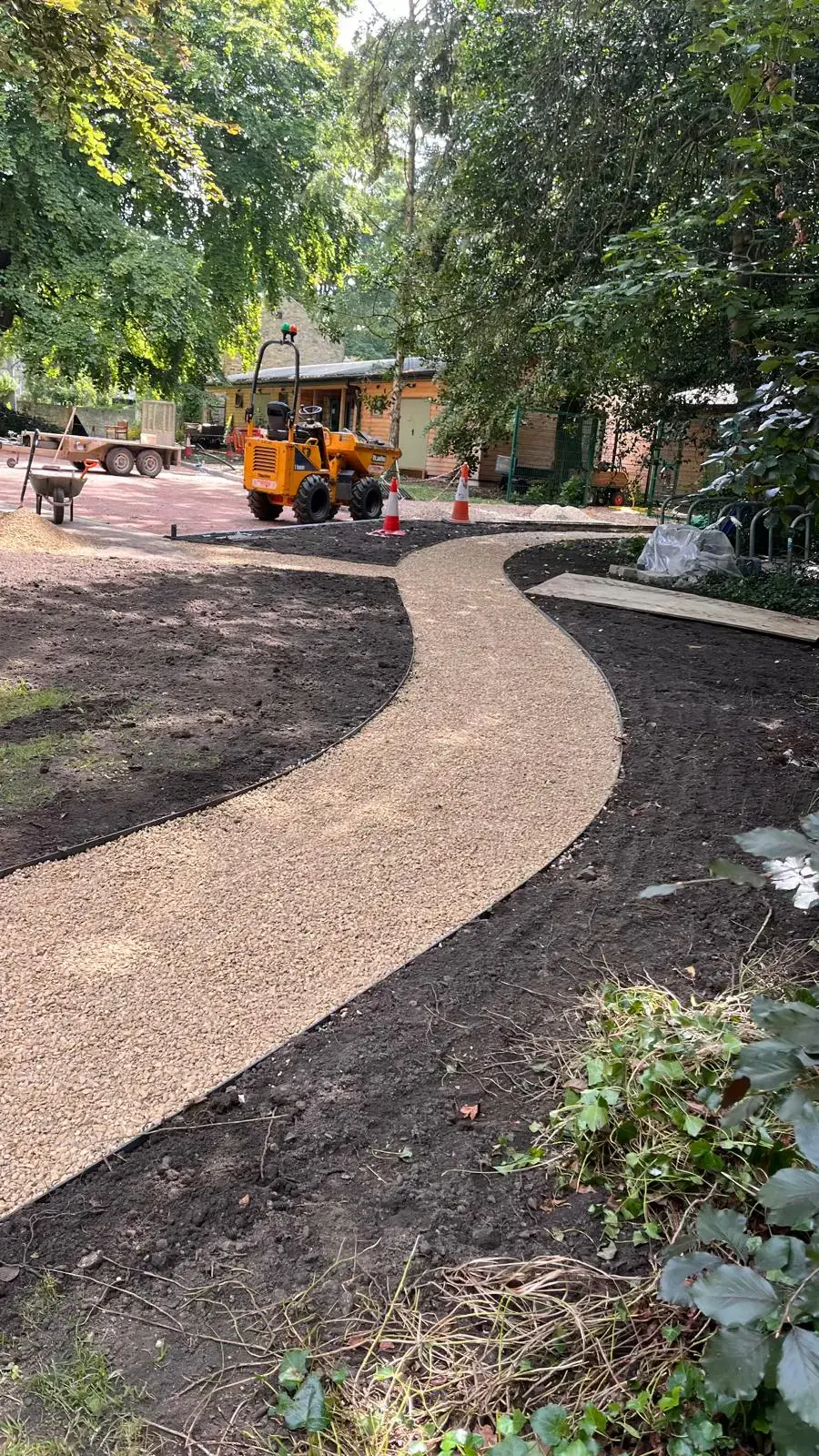 Curved gravel path through landscaped grounds