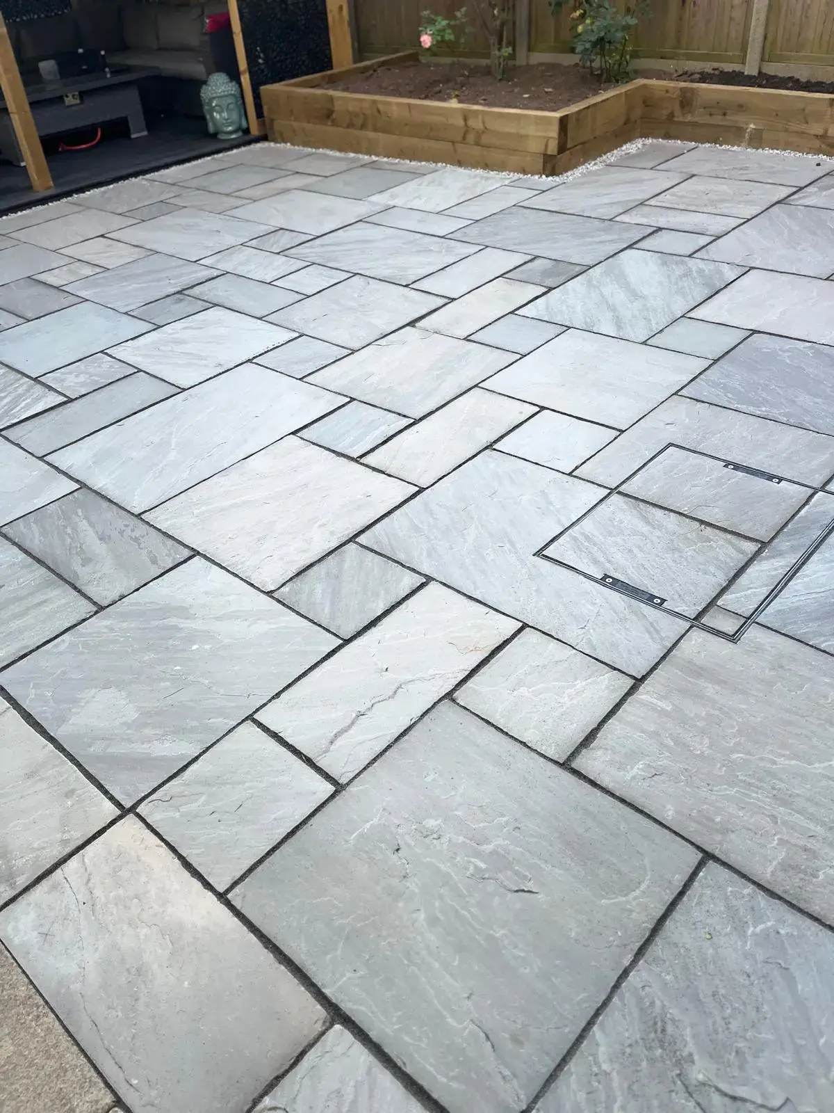 Finished stone patio with raised beds