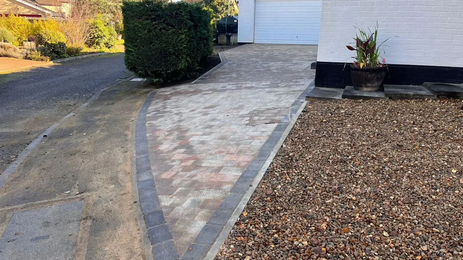 Block paved driveway and gravel bed