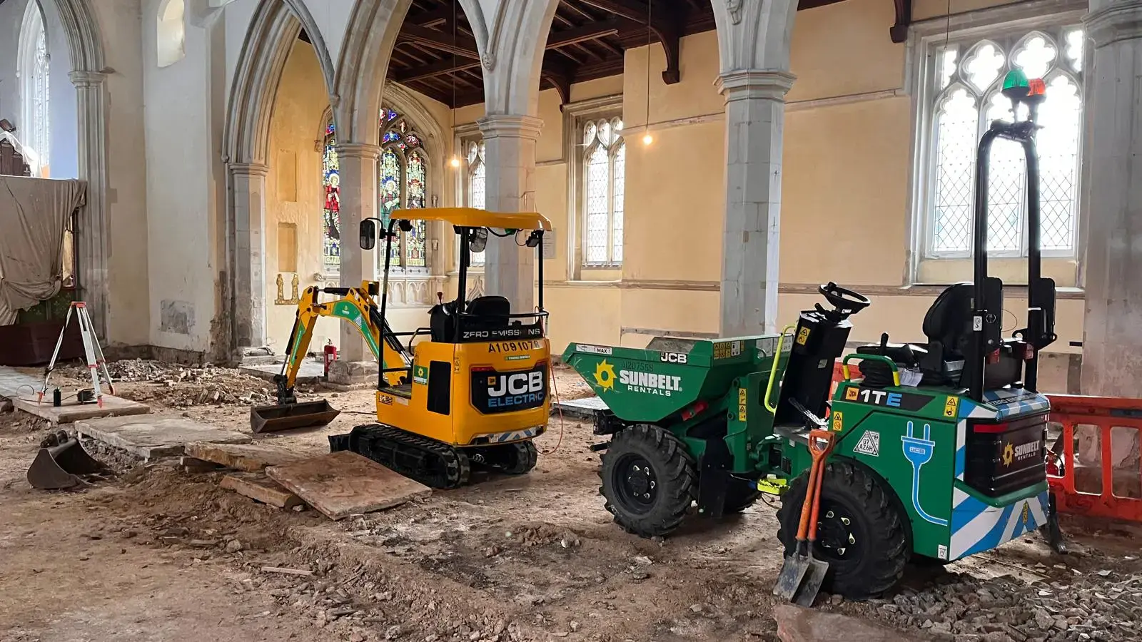 Excavator and dumper inside a church renovation