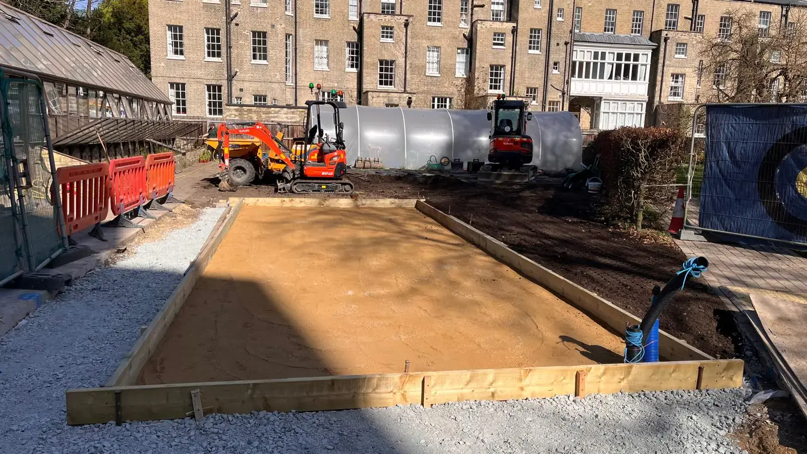 Framed concrete base with excavators