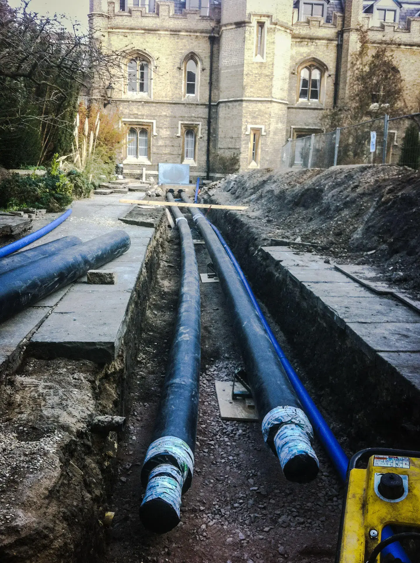 Utility pipe trench beside a historic building