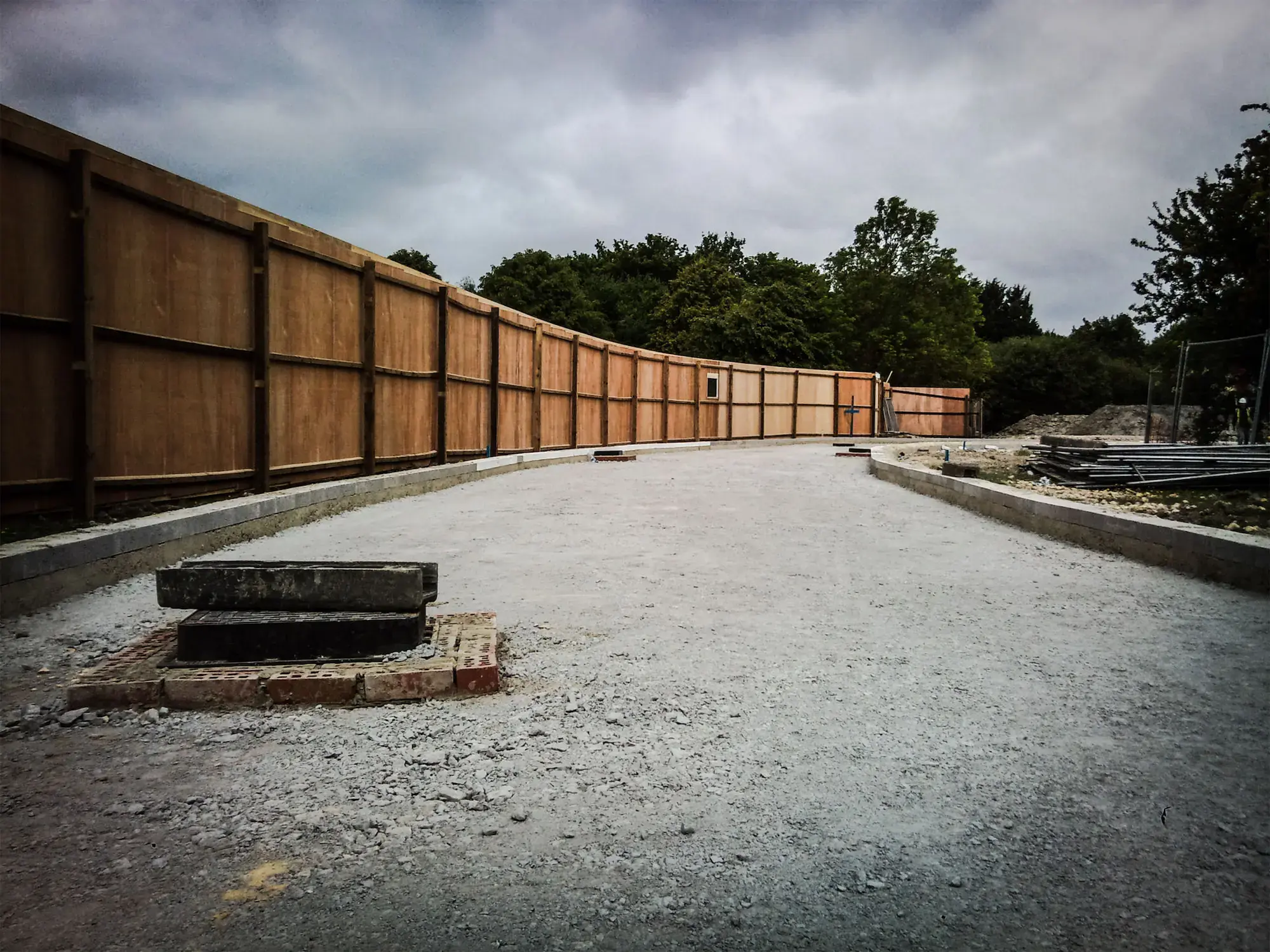 Compacted sub-base beside a fence line